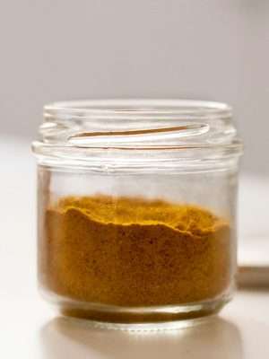 clear glass jar with brown powder