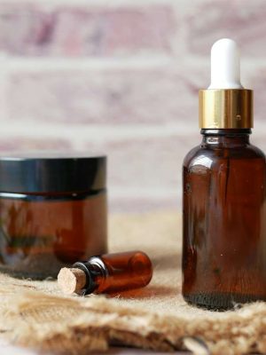 brown glass bottle on brown textile